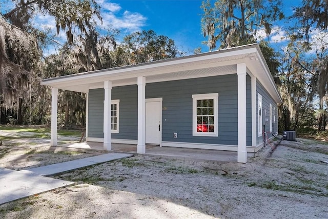 view of front of property with cooling unit and covered porch