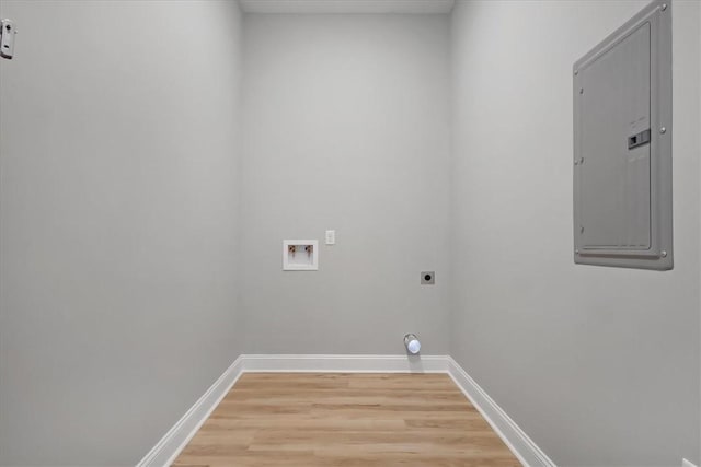 clothes washing area featuring hookup for a washing machine, electric panel, light hardwood / wood-style flooring, and electric dryer hookup