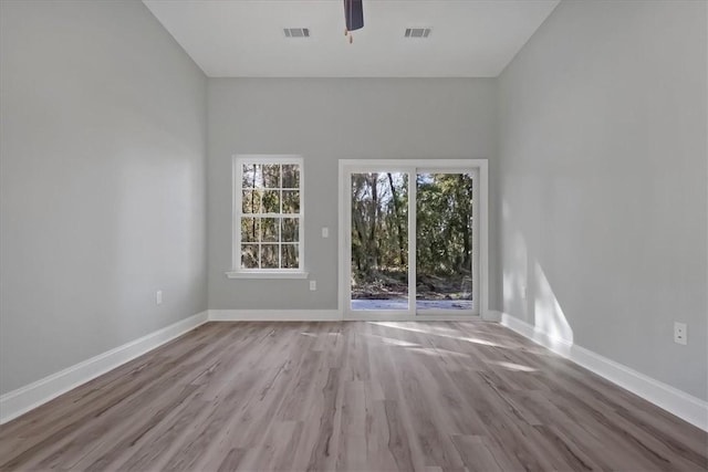 spare room with ceiling fan and light wood-type flooring