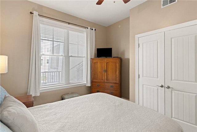 bedroom with ceiling fan and a closet