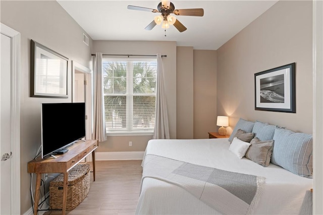 bedroom with wood-type flooring and ceiling fan