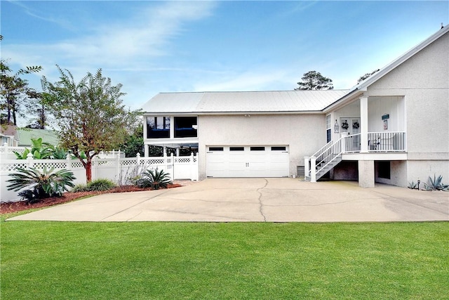 view of front of house with a garage and a front lawn