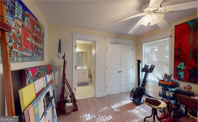 interior space with ceiling fan and light colored carpet