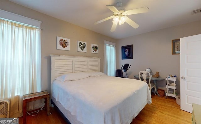 bedroom featuring light wood-type flooring and ceiling fan