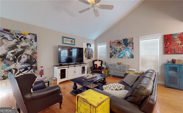 living room featuring ceiling fan, high vaulted ceiling, and light hardwood / wood-style floors