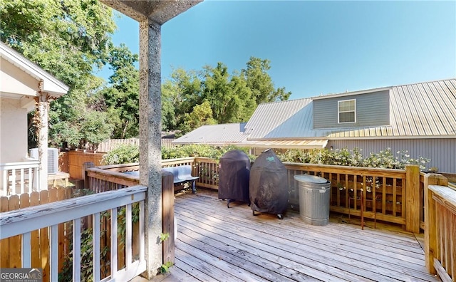 wooden terrace featuring area for grilling