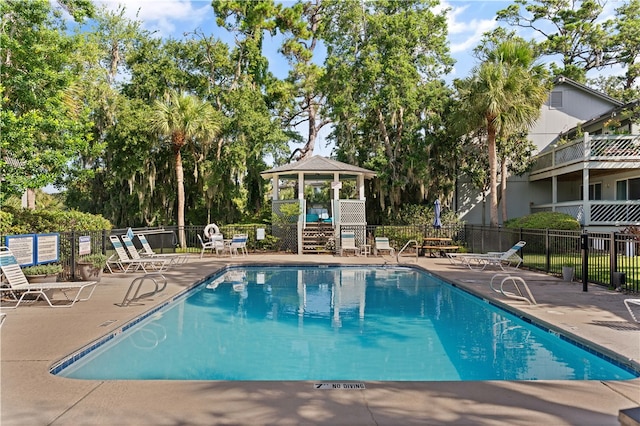 view of swimming pool with a gazebo and a patio