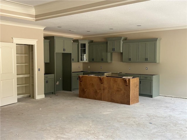 kitchen with a textured ceiling, a center island, and crown molding