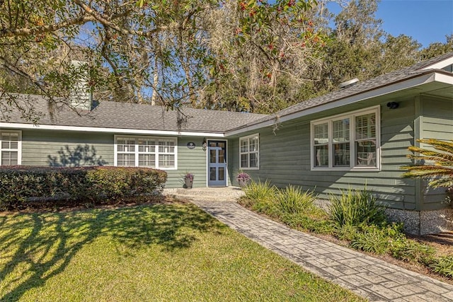 ranch-style home featuring a front yard