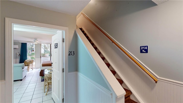 hall with a wall mounted air conditioner and light tile patterned flooring