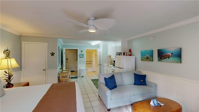 living room featuring ceiling fan, ornamental molding, sink, and light tile patterned floors