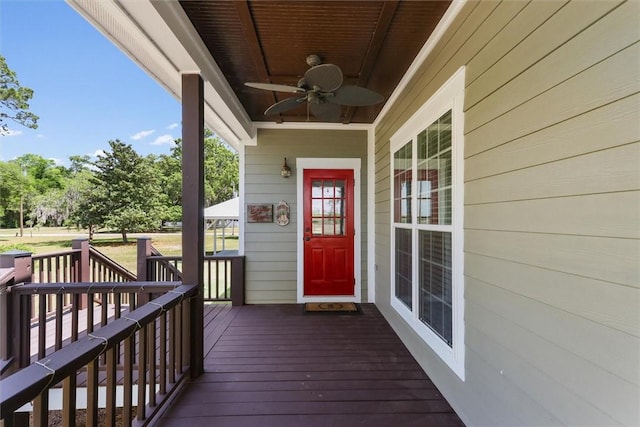 wooden terrace with a ceiling fan and covered porch