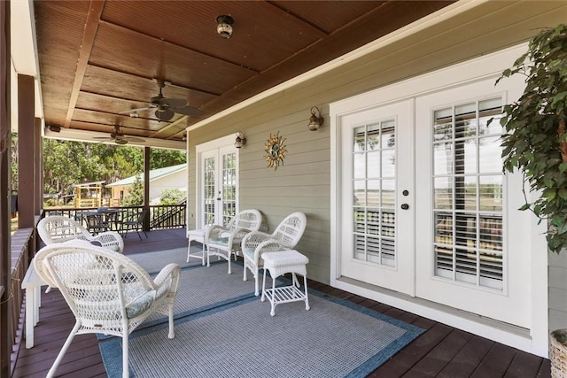 exterior space featuring a deck, ceiling fan, and french doors