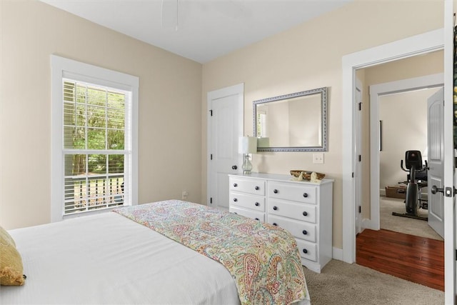 bedroom with baseboards and light colored carpet