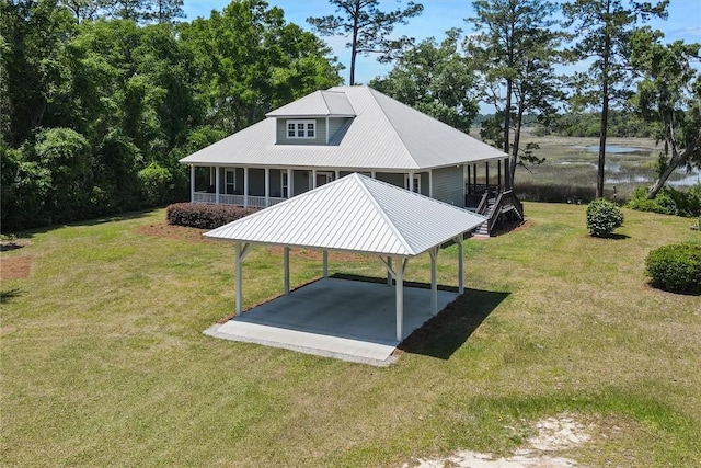 view of community featuring a lawn and a detached carport