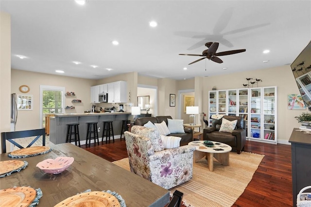 living room with recessed lighting, a ceiling fan, and dark wood-style floors