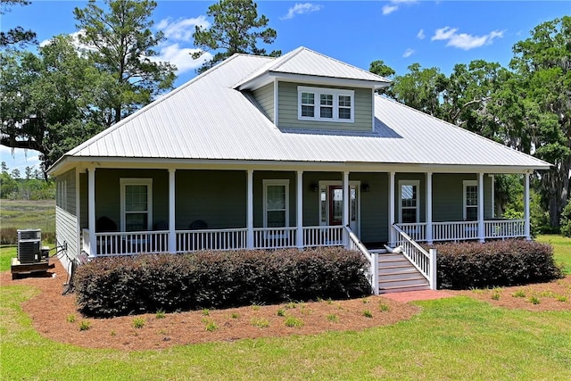 1261 Otter Slide Loop, Townsend, GA 31331 - country-style home with a porch, metal roof, central AC, and a front lawn