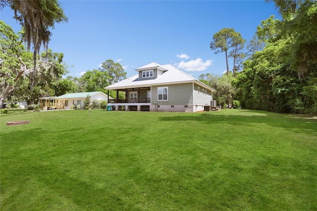 rear view of property featuring a lawn