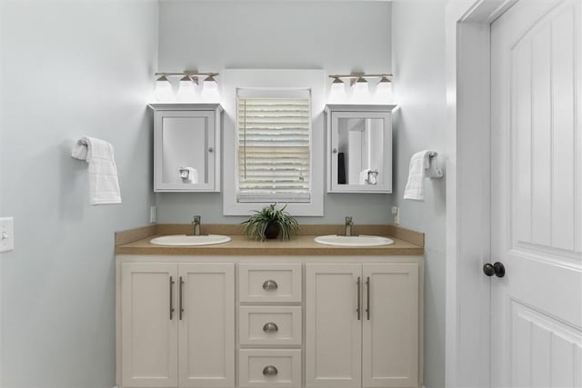 bathroom featuring a sink and double vanity
