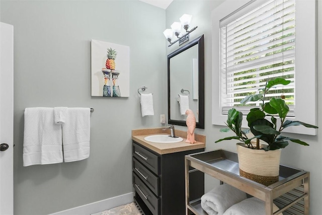 bathroom with vanity and baseboards