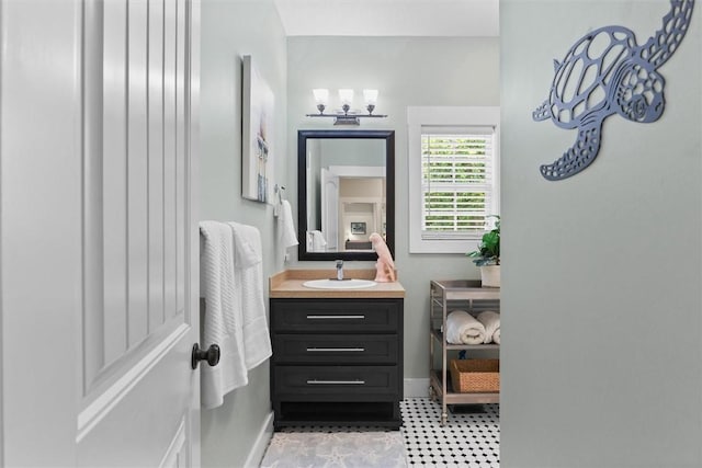 bathroom with vanity, baseboards, and tile patterned floors