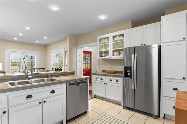 kitchen featuring a sink, white cabinetry, and stainless steel appliances