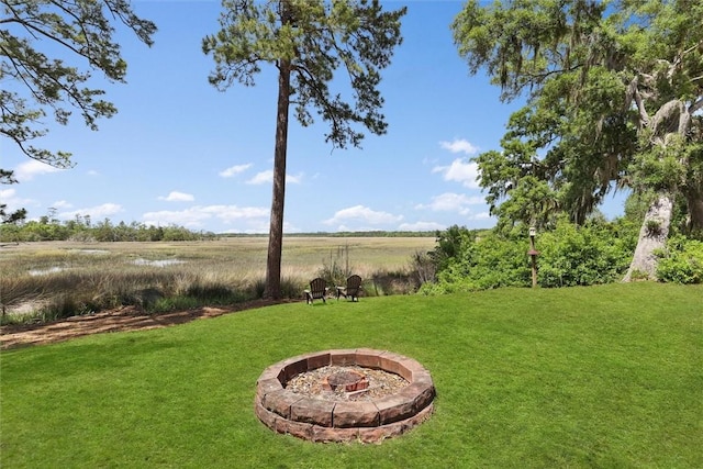 view of yard featuring a rural view and a fire pit