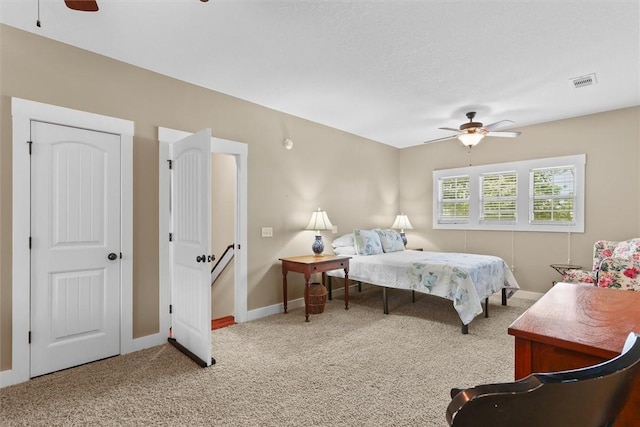 carpeted bedroom with baseboards, visible vents, and ceiling fan