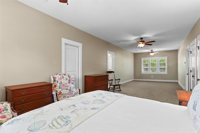 bedroom with ceiling fan, carpet flooring, and baseboards