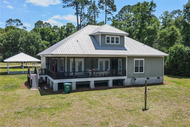 back of house featuring french doors, a yard, metal roof, and crawl space