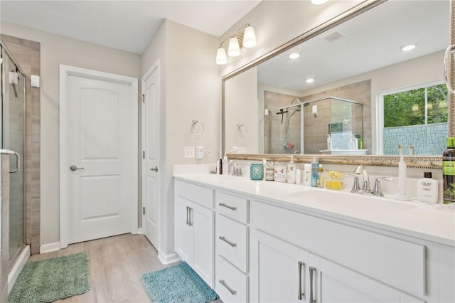140 Clearwater Dr, Brunswick, GA 31523 - bathroom featuring double vanity, a stall shower, and a sink