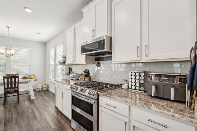 140 Clearwater Dr, Brunswick, GA 31523 - kitchen featuring a notable chandelier, visible vents, backsplash, white cabinets, and appliances with stainless steel finishes