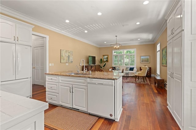 kitchen with ornamental molding, white appliances, sink, pendant lighting, and white cabinetry