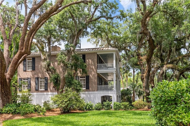 rear view of property with a yard