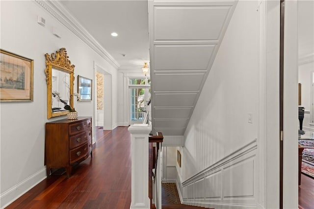 stairway with hardwood / wood-style floors and ornamental molding