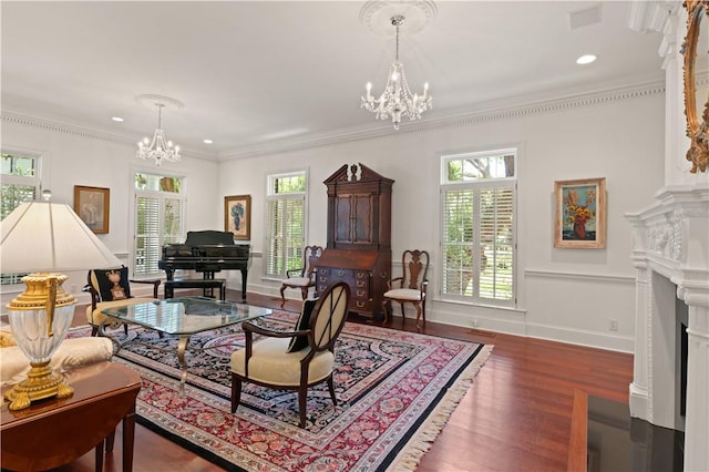 living room featuring dark hardwood / wood-style floors, an inviting chandelier, a wealth of natural light, and crown molding