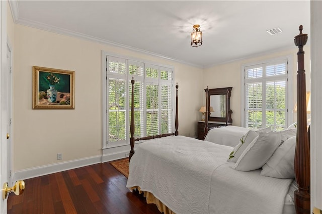 bedroom with dark hardwood / wood-style floors, ornamental molding, and multiple windows