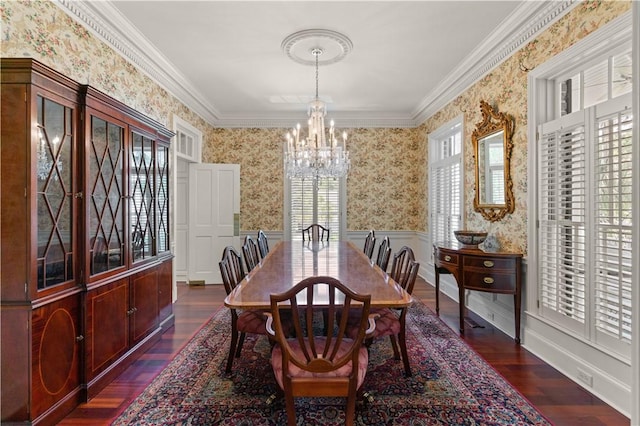 dining area featuring dark hardwood / wood-style flooring, ornamental molding, and a chandelier