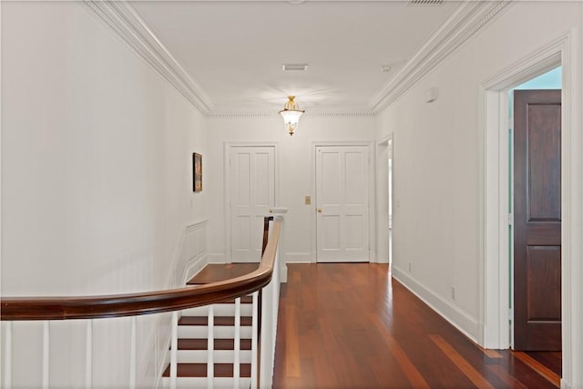 hall with dark hardwood / wood-style flooring and crown molding