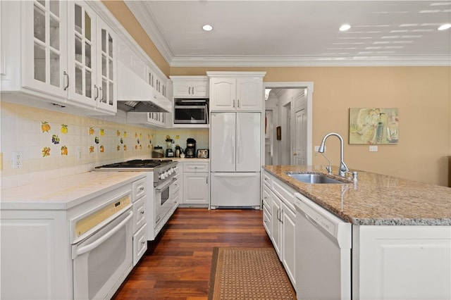 kitchen with white cabinets, sink, built in appliances, light stone counters, and dark hardwood / wood-style flooring