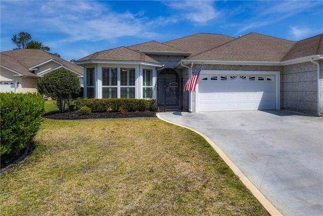 ranch-style home featuring a front yard, a shingled roof, driveway, and an attached garage