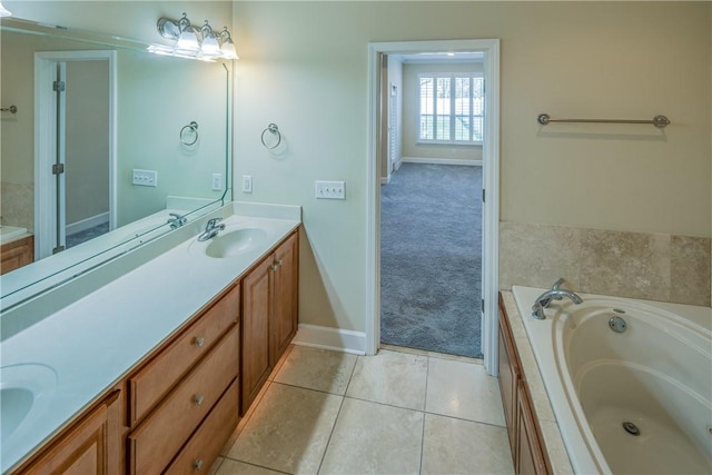 full bathroom with baseboards, double vanity, a sink, tile patterned flooring, and a garden tub