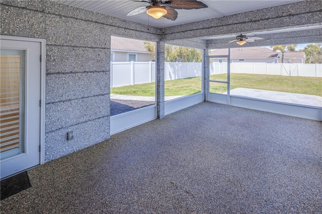 unfurnished sunroom with a ceiling fan and visible vents