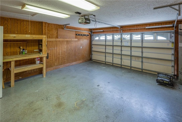 garage featuring a garage door opener and wood walls