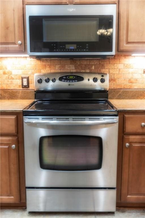 kitchen featuring tasteful backsplash, brown cabinets, and appliances with stainless steel finishes