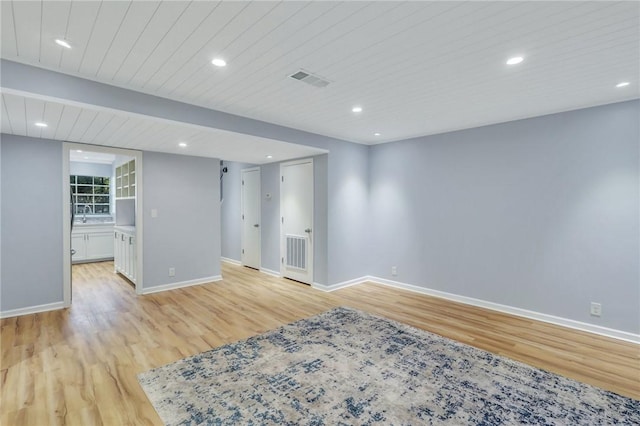 spare room with light wood-type flooring and sink