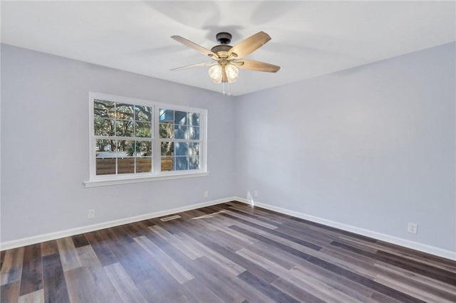 empty room featuring ceiling fan and dark wood-type flooring