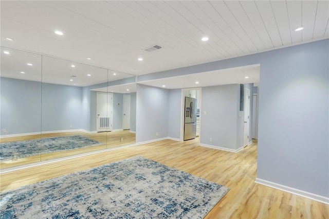 interior space with stainless steel refrigerator with ice dispenser and light hardwood / wood-style flooring