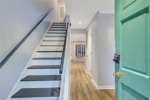 stairs with hardwood / wood-style flooring