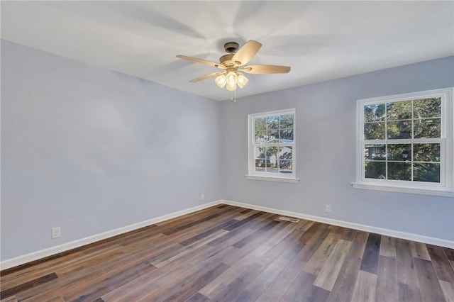 spare room featuring ceiling fan and dark wood-type flooring